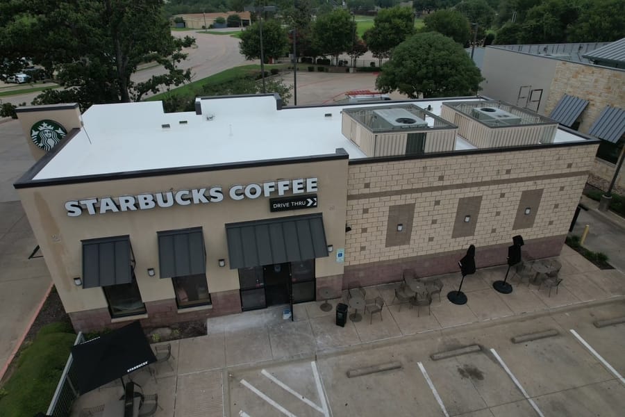 Commercial storefront roof replaced by Select Roofing, aerial view